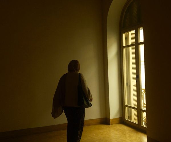 Person feeling serene and balanced in a naturally lit room.