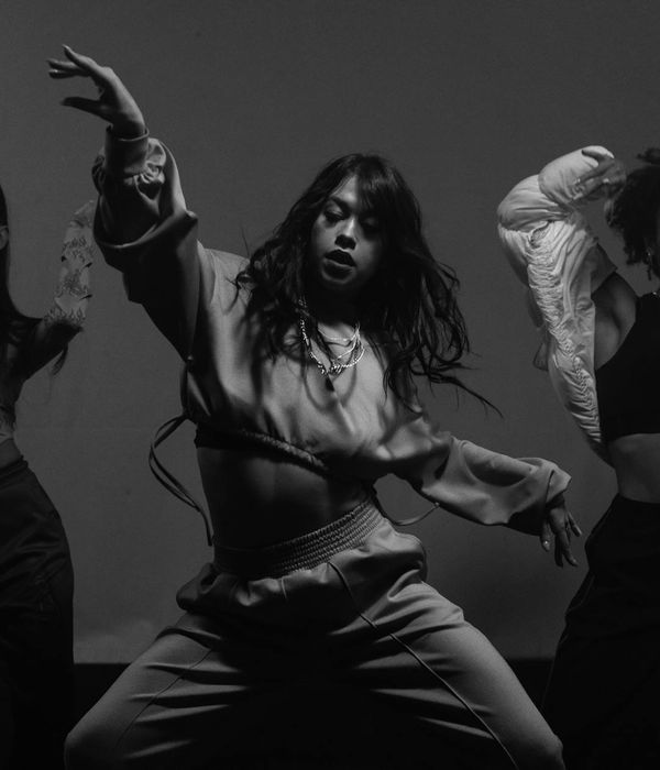 Woman in a graceful movement pose feeling energetic and well.